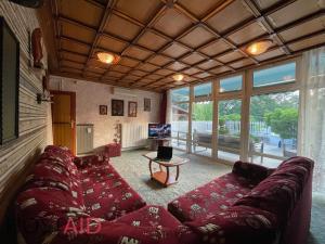 a living room with a couch and a tv at STÉG64 - Ráckeve - hostAID in Ráckeve