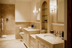 a bathroom with two sinks and a toilet at Links House at Royal Dornoch in Dornoch