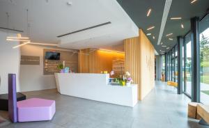 a lobby with a white counter in a building at Hotel Stadio & Spa in San Bonifacio