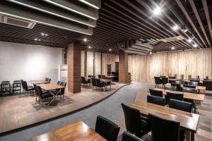 a dining room with wooden tables and chairs at Jeonju Jazz Around Hotel in Jeonju