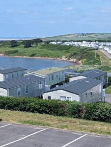 a group of houses next to a body of water at Panoramic Views Relaxing Caravan Littlesea Haven Weymouth in Weymouth