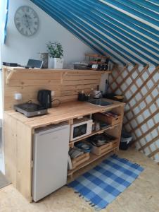 a kitchen in a tent with a counter and a sink at Jurta na zvířecí farmě 