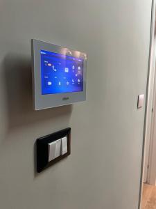 a flat screen tv hanging on a wall at La Cattedrale in Reggio di Calabria