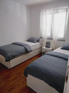 Posteľ alebo postele v izbe v ubytovaní Apartment KIM