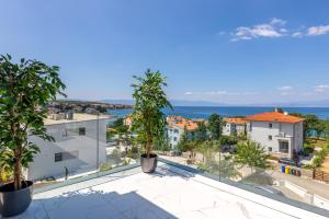 a view from the balcony of a house with trees at Apartment Magdalena in Malinska