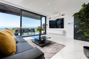 a living room with a couch and a large window at Apartment Magdalena in Malinska