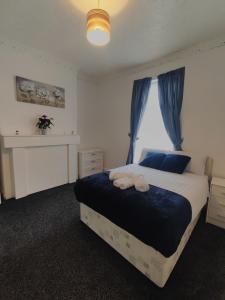 a bedroom with a large bed with a window at A&A Luxury Stay Noble Street in Sunderland
