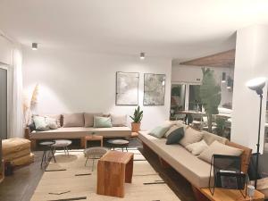 a living room with a couch and a table at Sãone Guesthouse & Coworking in Ericeira
