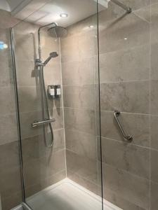 a shower with a glass door in a bathroom at Honeypot Cottage in Centre of Bowness in Bowness-on-Windermere