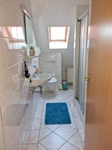 a bathroom with a sink and a toilet and a tub at Windlicht im 1 Stockwerk in Norddeich +21 photos