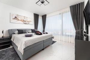 a bedroom with a bed and a large window at Apartment Magdalena in Malinska