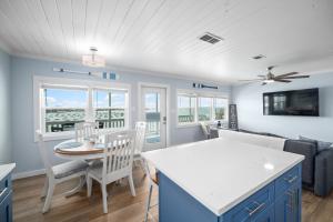 a kitchen and living room with a table and chairs at Reel House in Gulf Shores