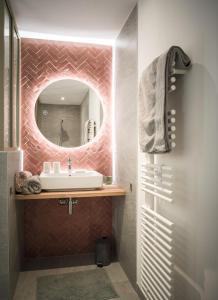 a bathroom with a sink and a mirror at Venez Chez Vous - Chalet de Bredanne - Bord du lac in Doussard