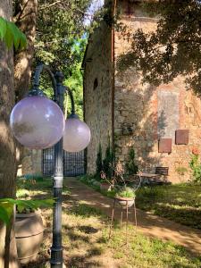 a street light with two glass globes and a bench at La Villa del Borgo in Massa Marittima