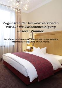 a bedroom with a bed and a chandelier at Just Sleep Trier in Trier