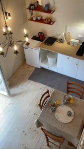 a kitchen with a table and chairs and a kitchen with a counter at Apartman Ezza in Lopud +14 photos