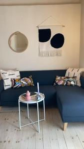 a living room with a blue couch and a table at Apartman Ezza in Lopud