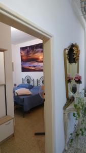a bedroom with a bed and a painting on the wall at Al 12 in Marina di Pisa