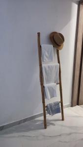 a towel rack with a stack of towels next to a wall at reAdy studio in Skiathos