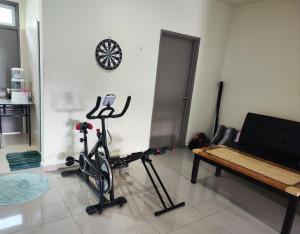a room with a gym with a treadmill and a bench at homestay sayangku islam 4 bilik in Segamat