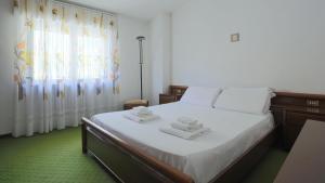 a bedroom with a bed with two towels on it at Italianway - Via Pighini 75 in San Fedele Intelvi