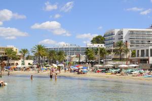 a group of people on a beach in the water at Hotel Osiris Ibiza in San Antonio