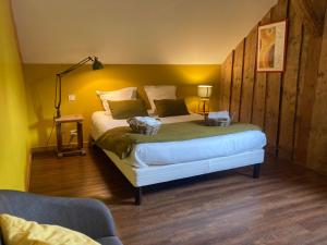 a bedroom with a large bed in a room at Chez Jeanmyvonne in La Bresse
