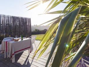 a table and chairs on a patio with a fence at Maison Bista Eder in Bidart