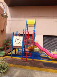 a playground with a colorful slide in front of a building at SAMI APARTMENT - Times Square KL in Kuala Lumpur