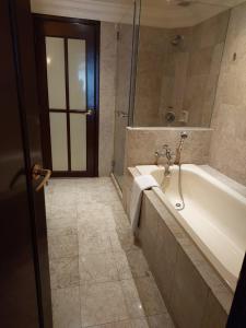 a bathroom with a bath tub and a shower at SAMI APARTMENT - Times Square KL in Kuala Lumpur