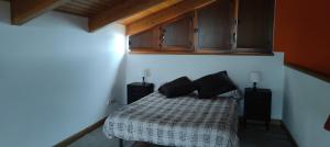 a bedroom with a bed with two pillows on it at La Casita de Tití in Pravia