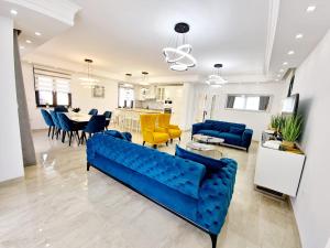 a living room with a blue couch and a dining room at Luxury Villa Laura in Malinska