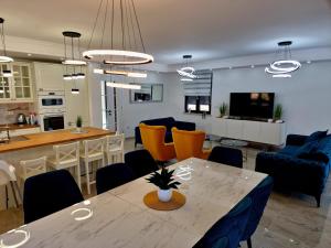 a kitchen and living room with a table and chairs at Luxury Villa Laura in Malinska