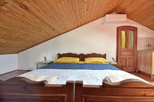 a bedroom with a large bed with a wooden ceiling at Only 250m from the sea in Funtana