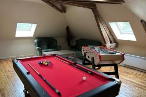 a living room with a pool table in a room at Gite Au Fil de lEau 