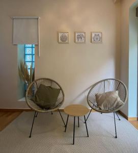 two chairs and a table in a living room at Studio for a couple in Athens