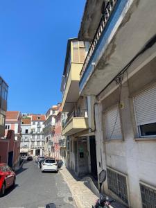 a street with cars parked on the side of a building at Santo Amaro Apartment in Lisbon