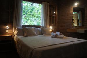 a bedroom with a large bed with towels on it at Lorelei in Mina Clavero