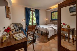a bedroom with a bed and a desk in a room at Agriturismo Cascina Monchiero in Bra