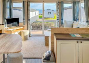 a living room with a couch and a table at Ladram Bay Holiday Park in Otterton