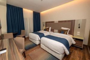 Postel nebo postele na pokoji v ubytování Helnan Mamoura Hotel & Events Center