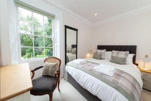 a bedroom with a bed and a desk and a chair at Beautiful Grade II Listed Apartments Sleeping 20 in Hexham