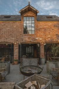 a brick building with a fountain in front of it at Outbuildings Dorset in Bridport