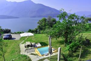 a villa with a swimming pool and a view of a lake at Grandin Holidayhouse in Domaso