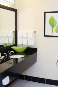 a bathroom with a green sink and a mirror at Fairfield Inn and Suites by Marriott Muskogee in Muskogee