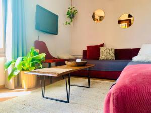 a living room with a couch and a table at Studio vue sur mer in Dar Bouazza