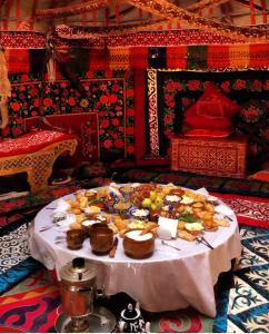 a table with a bunch of food on it at Юрта Qyran in Türgen +101 photos