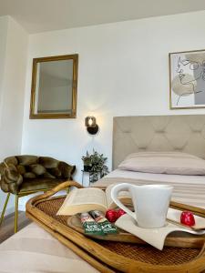 een bed met een dienblad met een kopje en een boek bij Holiday Home Mirela in Orebić