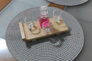 a tray with four glasses on a table at Mastic House in Chios