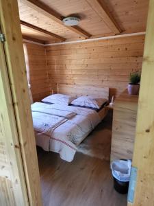 a bedroom with a bed in a wooden cabin at Gartentraum am Bauernhof in Obdach